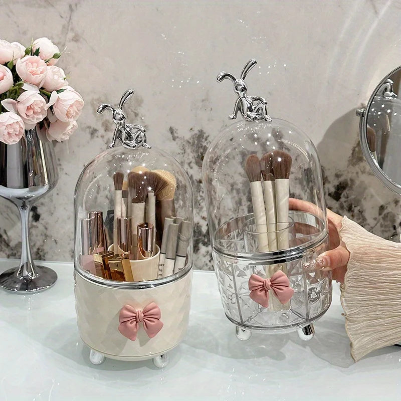 Makeup brush holders with decorative bows on a vanity table.