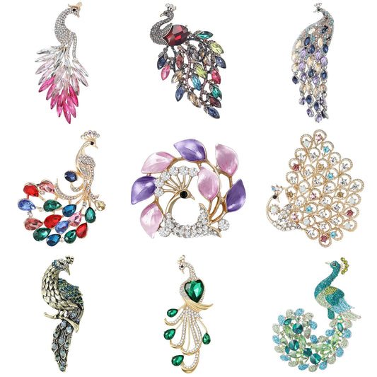 Collection of colorful peacock-shaped brooches on a white background