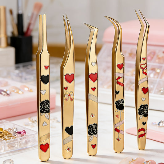 Set of gold tweezers with decorative designs on a blurred background